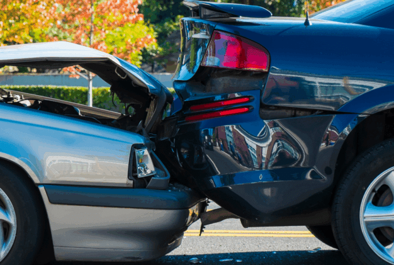 Image is of two cars that have been involved in a rear-end collision.