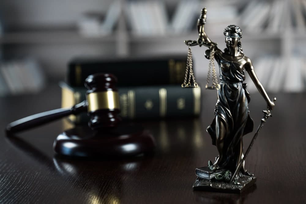 Legal concept image with gavel and Lady Justice.