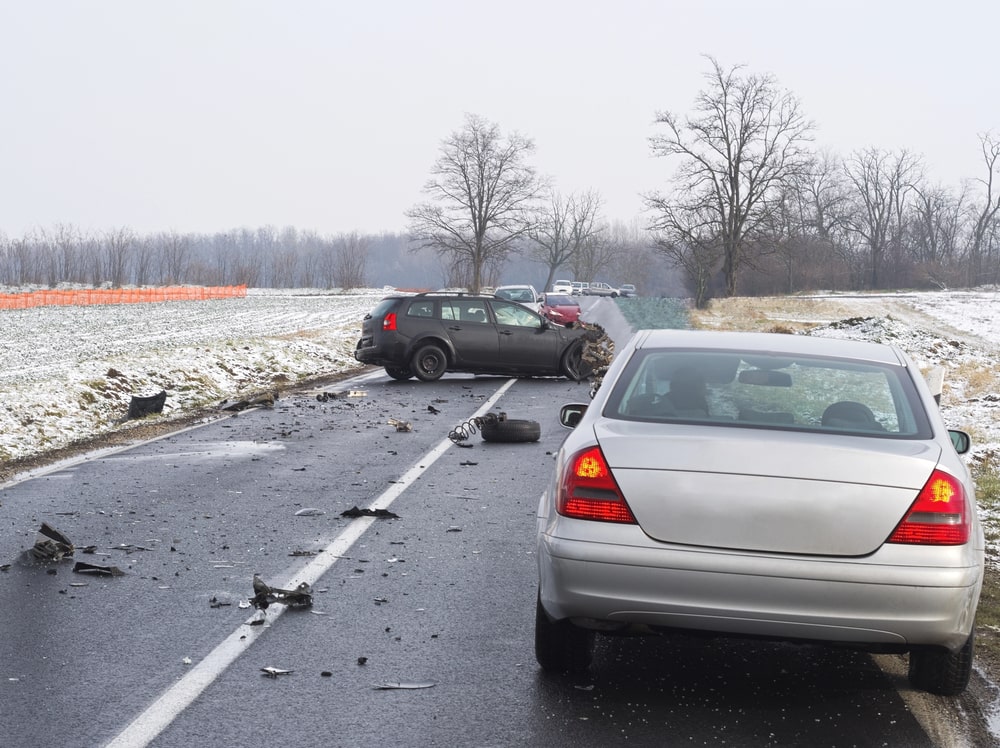 Two vehicles collide on a snowy Tennessee highway showing winter weather hazards and car accidents in TN.