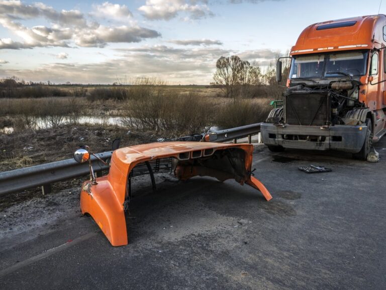 Orange semi-truck with front damage on a highway after a Tennessee semi-truck accident