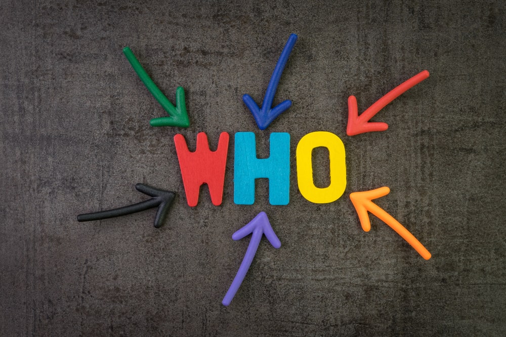 Colored arrows pointing toward the word WHO on a dark background representing the question of liability in a Tennessee semi-truck accident