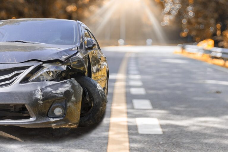 Image shows a heavily damaged car on the side of the road, concept of hit-and-run accidents in Murfreesboro and how victims face sudden financial and legal challenges.