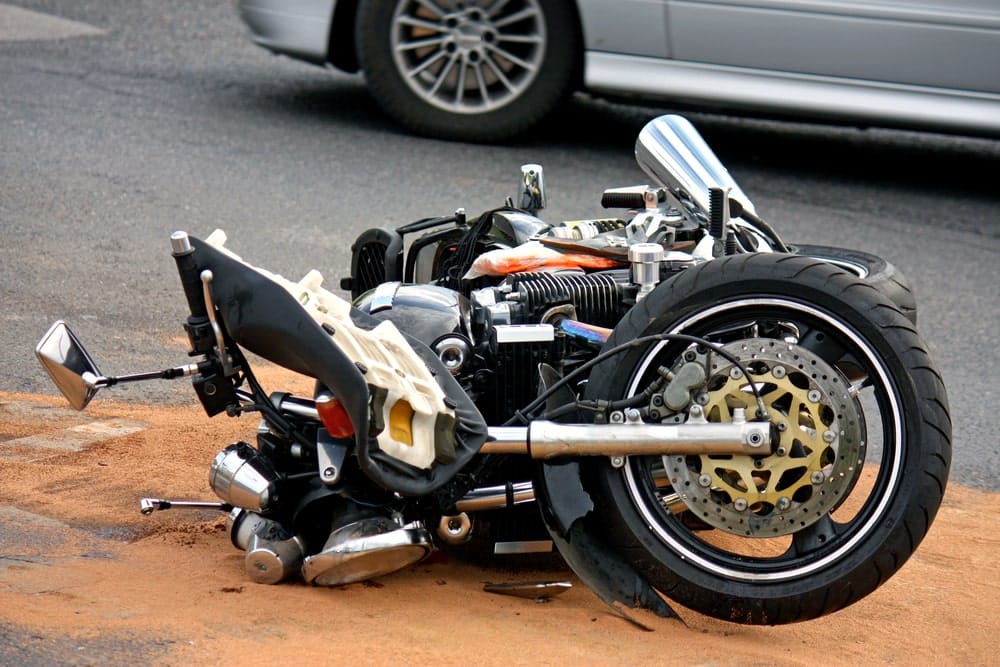 Image shows a severely damaged motorcycle lying on the road after a collision, illustrating the aftermath of a Tennessee motorcycle crash.