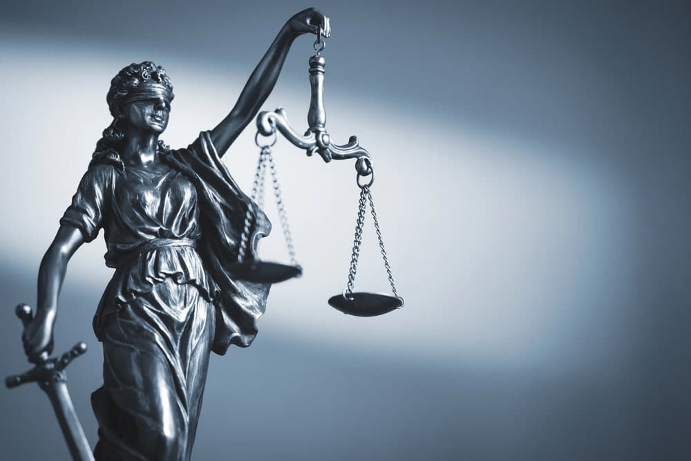 Image is of a Lady Justice statue holding balanced scales, symbolizing how fair testimony influences outcomes in Murfreesboro car accident cases.
