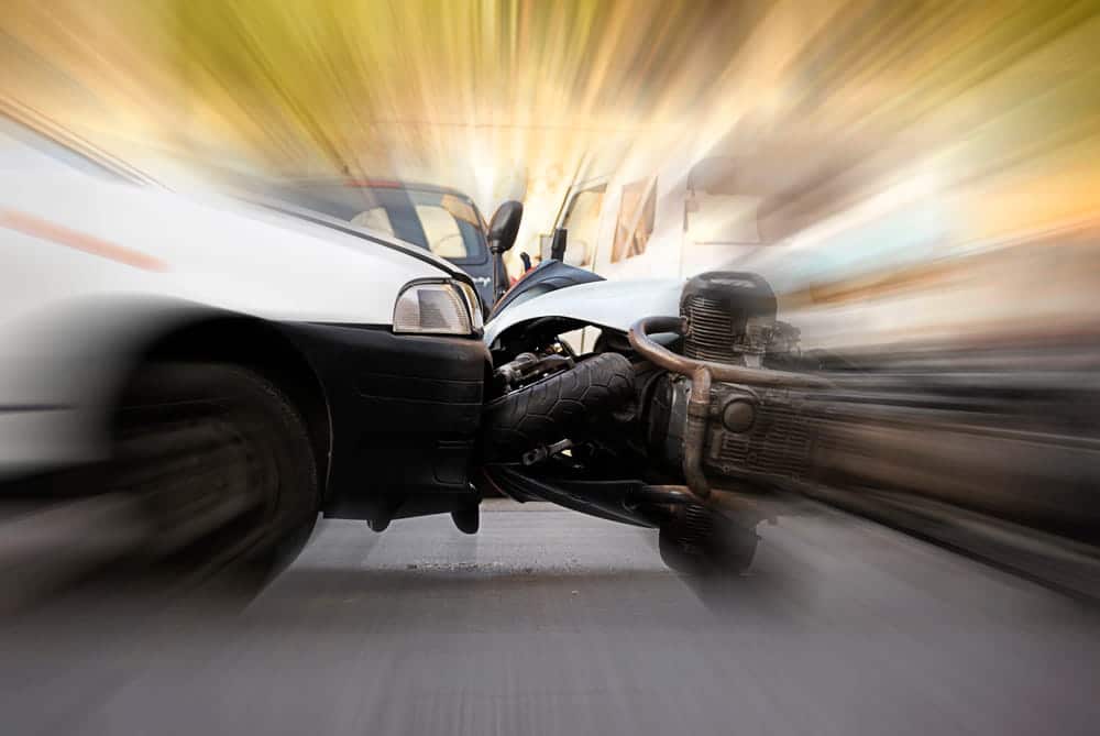 Image is of a motorcycle involved in a collision with a vehicle, illustrating how fatal motorcycle accidents can occur.