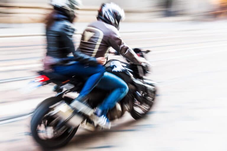 Image is of two people riding a motorcycle, concept of injuries that may lead passengers to file claims in Tennessee.