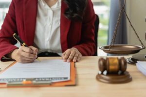 Image is of an attorney preparing legal documents at a desk, concept of filing truck accident claims before the legal deadline.