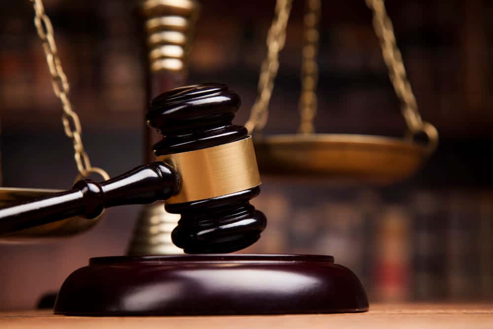 Image is of a judge's gavel with scales of justice in the background, concept of court proceedings in a truck accident lawsuit in TN.