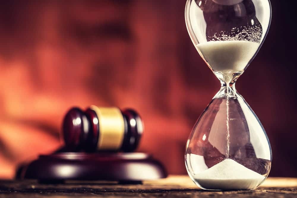 Image is of an hourglass beside a judge's gavel, concept of the timeline for a truck accident lawsuit in TN.