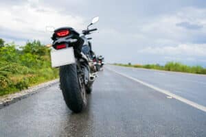 Image is of motorcycles on a wet roadway representing accident conditions and how comparative fault may influence motorcycle claims in TN