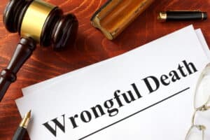 Image shows wrongful death documents beside a judge's gavel and legal materials, illustrating the legal process of filing a wrongful death claim after a Tennessee crash.